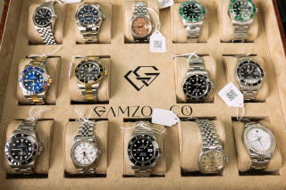 Luxury watches line a display case.