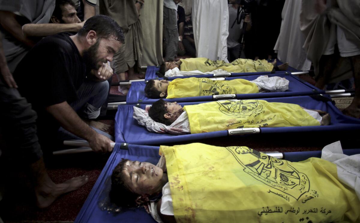 Palestinians mourn the deaths of four boys killed in Israel's bombardment of Gaza.