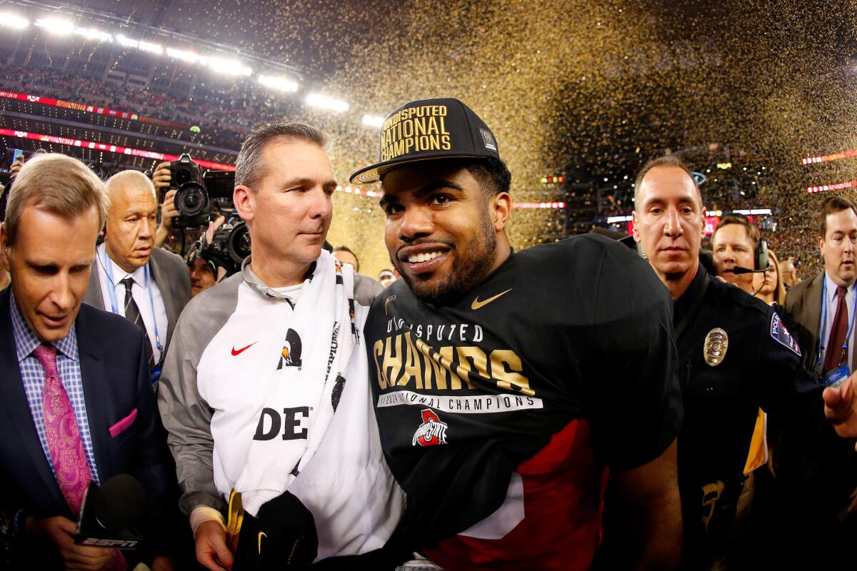Buckeyes Coach Urban Meyer and running back Ezekiel Elliott prepare to be interviewed following their victory over Oregon in the College Football Playoff championship game.