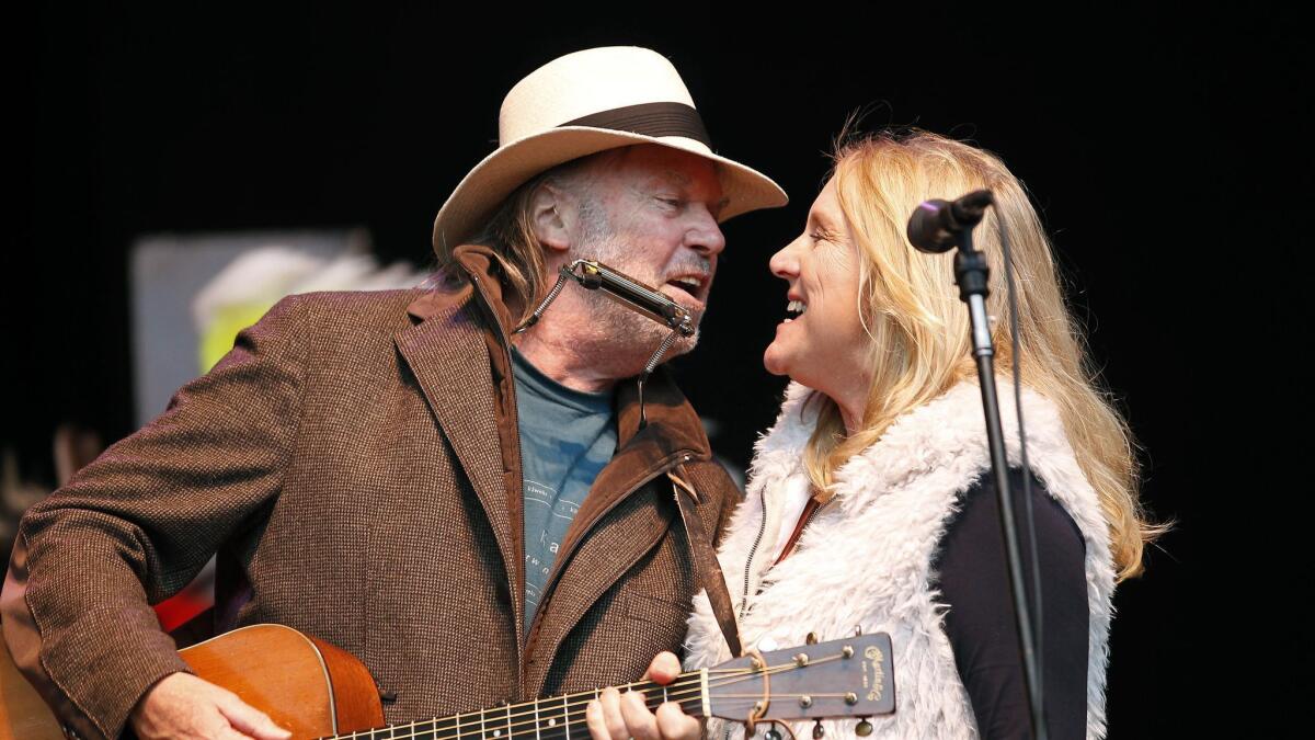 Neil and Pegi Young perform during the Bridge School Benefit concert in 2010.