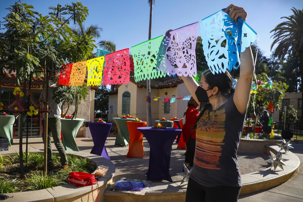 A volunteer helps decorate the courtyard