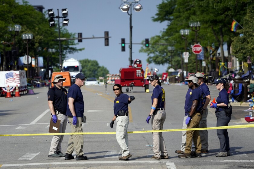 FBI agents and crime scene tape in a suburban street