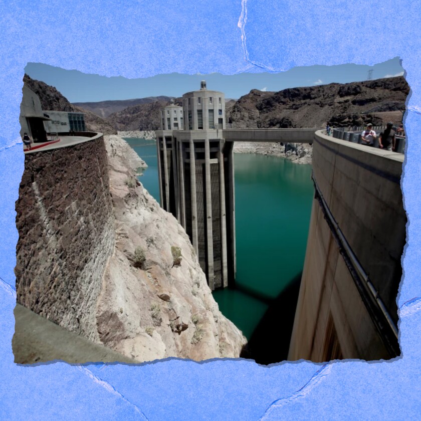 Visitors walk on Hoover Dam high above Lake Mead. 