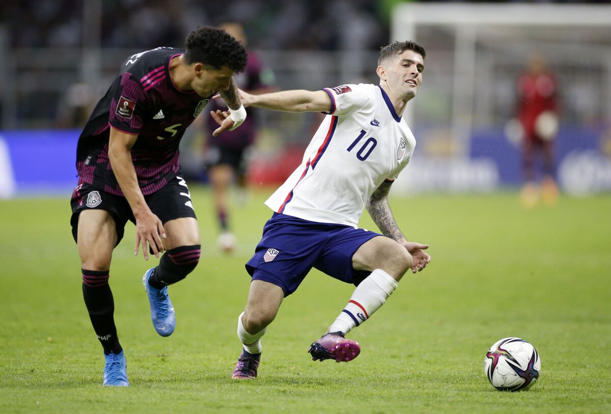 Mexico defender Jorge Sánchez, left, tries to steal the ball away from U.S. forward Christian Pulisic in the second half.