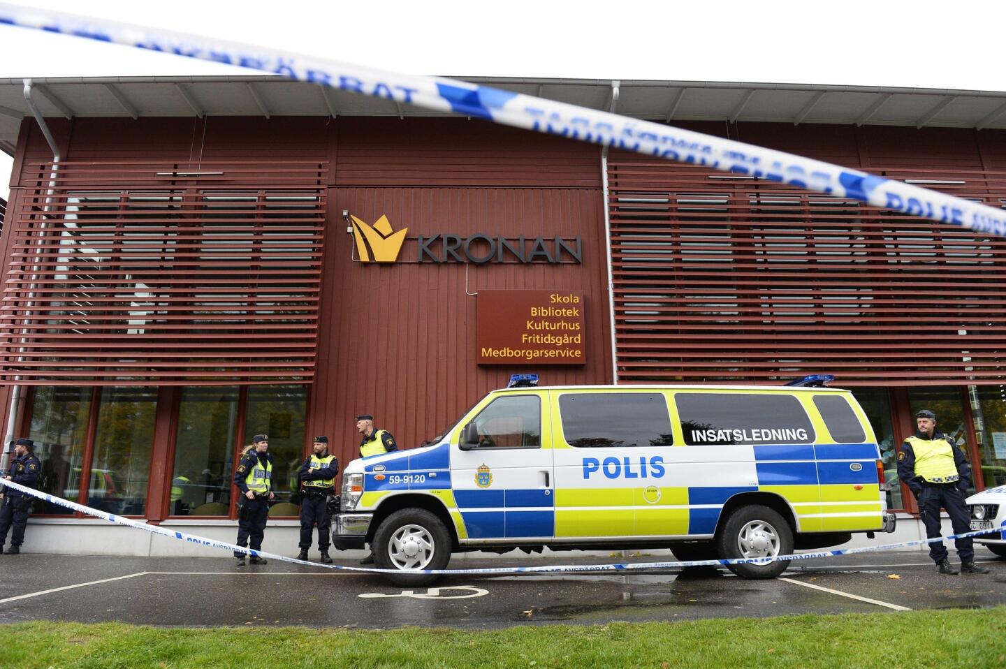 Police cordon off a school in southwestern Sweden where a masked man armed with a knife and possibly a sword killed a teacher and student.