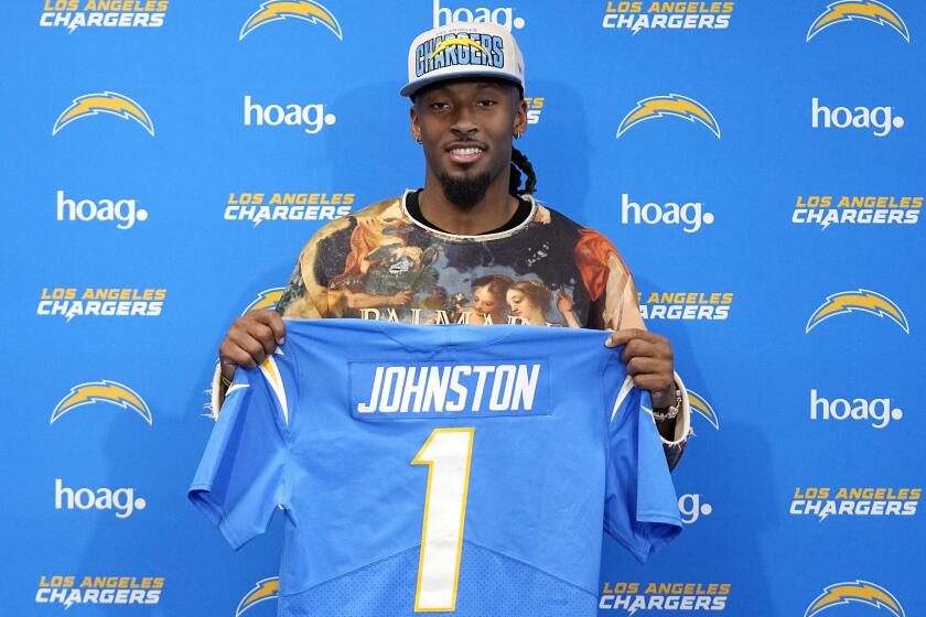 Quentin Johnston poses with his Chargers jersey. 