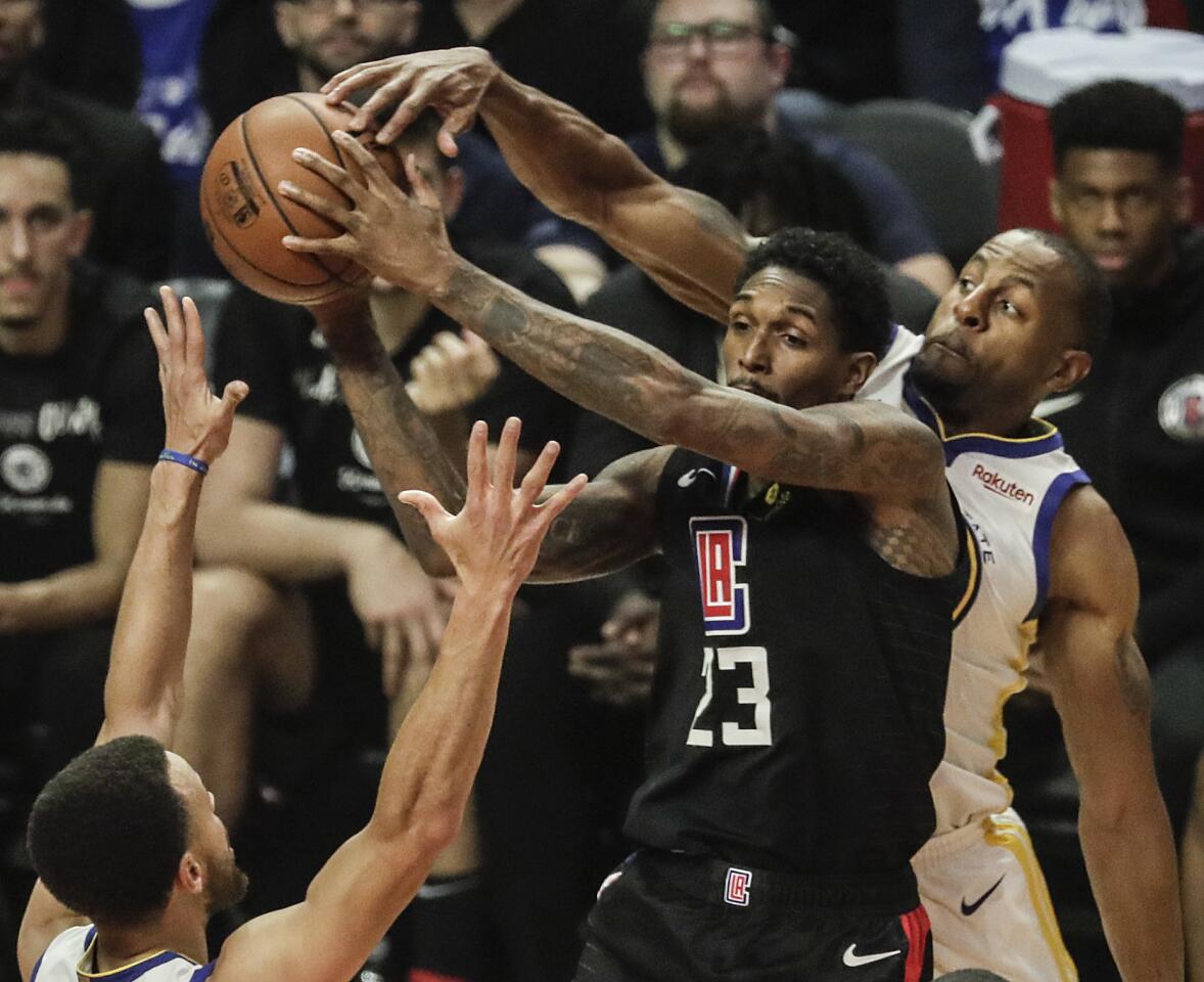 Clippers' Lou Williams is tightly guarded by Warriors' Andre Iguadala during the first quarter.