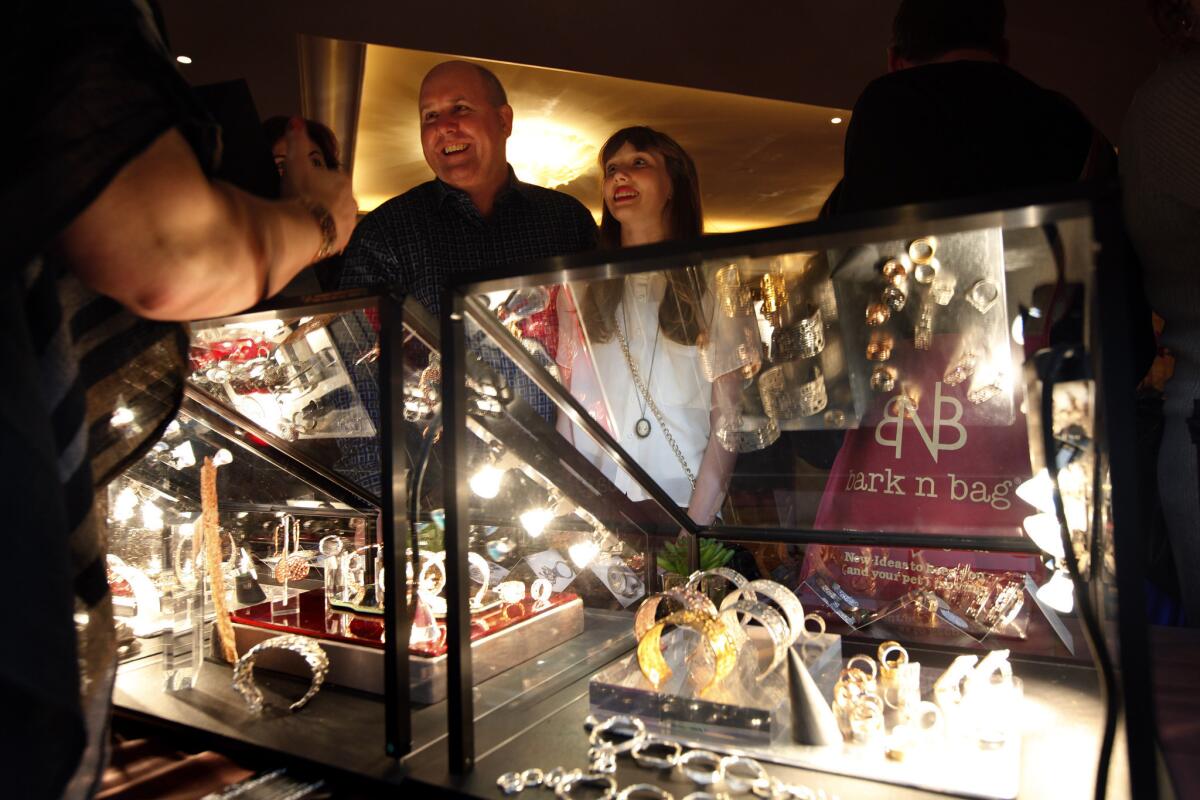 Actor James DuMont of "Dallas Buyers Club," and his daughter Sinclair, 12, talk with Annamarie Sabo at the La Corza booth at the Ultimate in Luxury Red Carpet Style Lounge co-hosted by Wolfgang Puck and benefiting the Society for the Prevention of Cruelty to Animals Los Angeles on Saturday at the Montage Hotel in Beverly Hills.