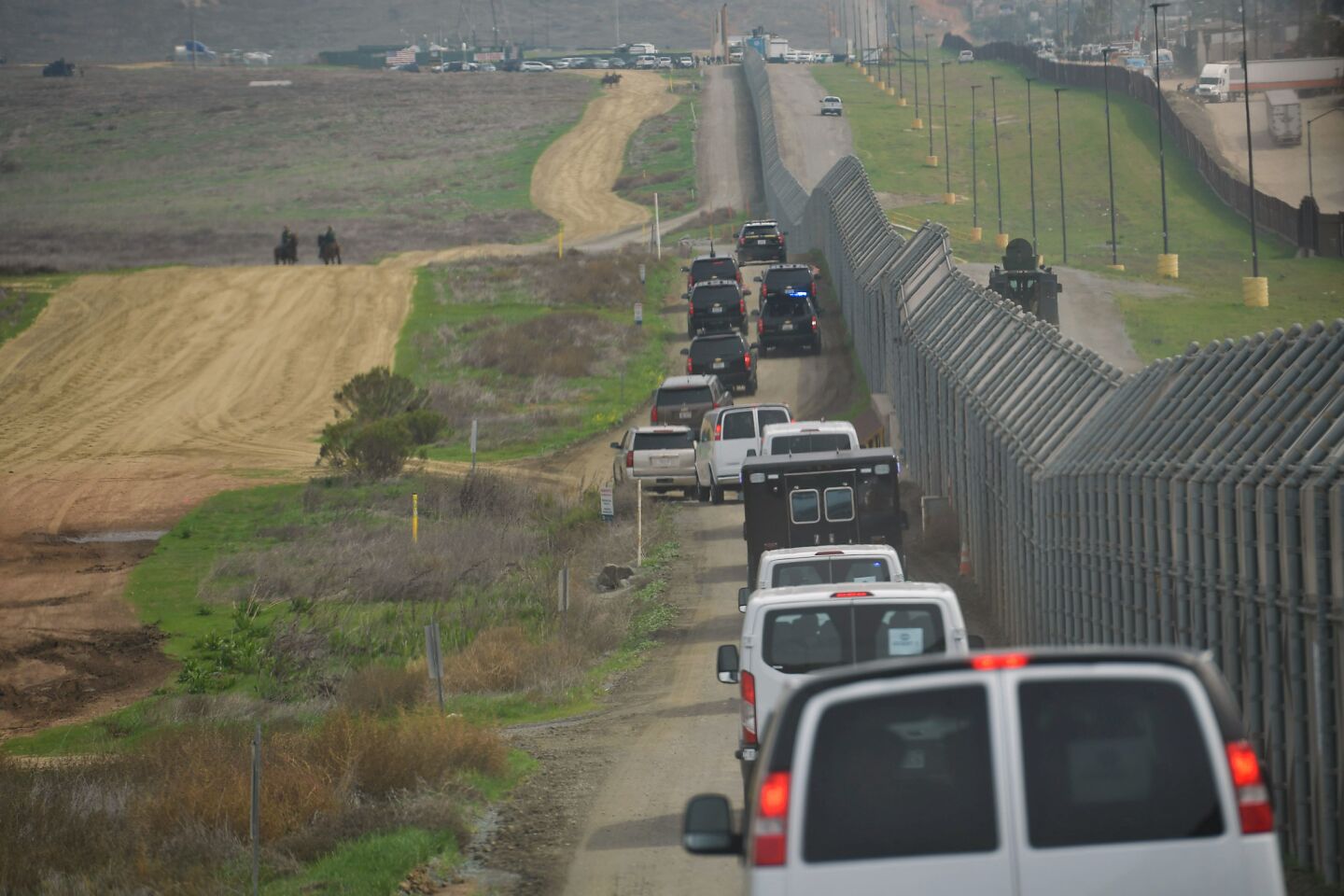 President Trump's motorcade makes its way along the border where he inspected wall prototypes near San Diego on March 13.