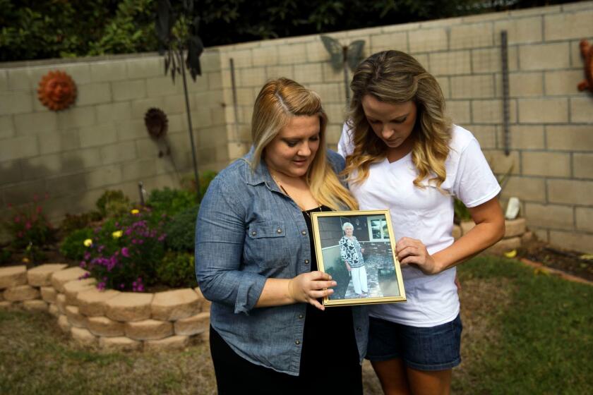 Halie Griffin and sister Katie Howe, grandchildren of grandmother Julie Shepherd (cq) stand for a portrait at Shepherd's home on Friday, September 22, 2017 in West Covina, Calif. Julie Shepherd, 84, became paralyzed and then developed bronchitis and died from the disease West Nile Virus. (Patrick T. Fallon/ For The Los Angeles Times)