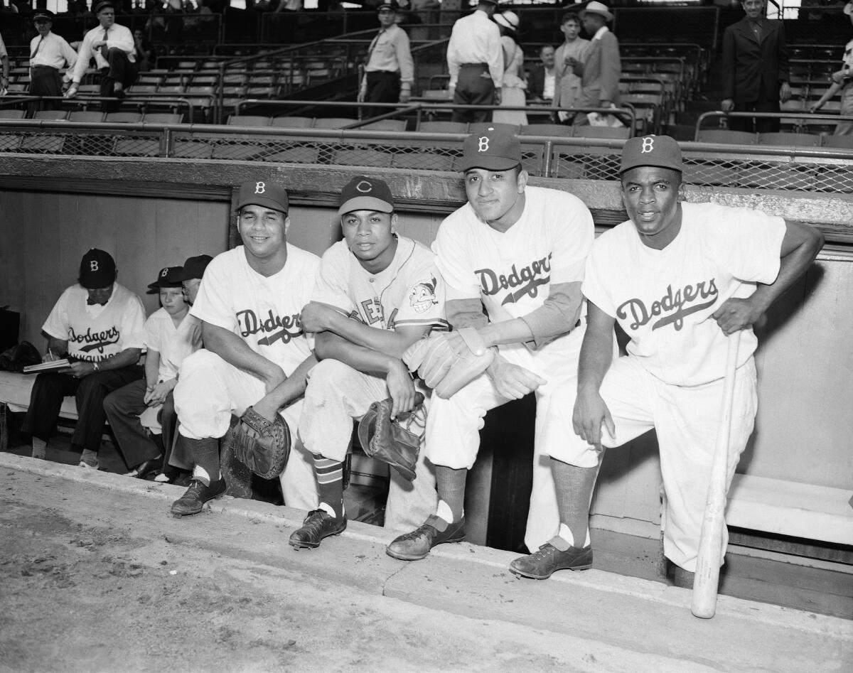 Photograph of Jackie Robinson and Roy Campanella with Brooklyn Dodger  teammates