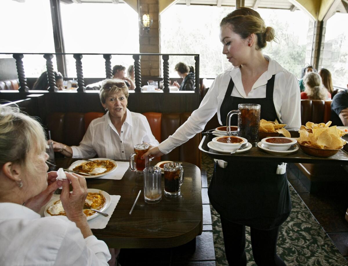 Ernie's Jr. Taco House waitress Tiffany Alvarado serves up lunch for Glendale residents Susan Schachtner, 56, left, and her mother Jackie Waldron, 80, right, at the Eagle Rock landmark restaurant on Thursday, April 17, 2014. Ernie's Jr. will close Saturday.