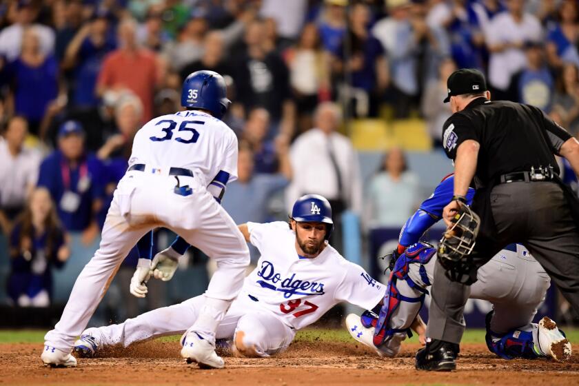 LOS ANGELES, CA - OCTOBER 14: Charlie Culberson #37 of the Los Angeles Dodgers scores off a single from Justin Turner #10 during the seventh inning against the Chicago Cubs in Game One of the National League Championship Series at Dodger Stadium on October 14, 2017 in Los Angeles, California.