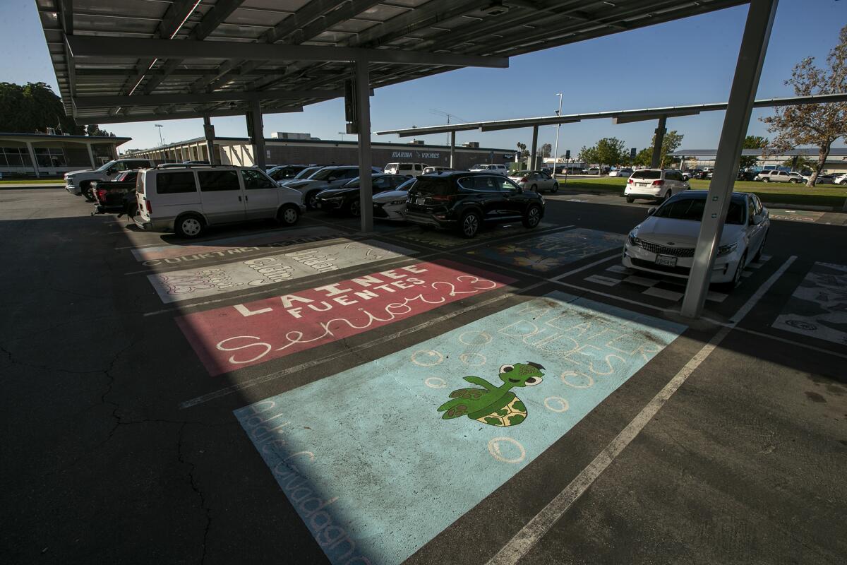 Colorful parking spaces adorn the lot in front of Marina High School on Thursday in Huntington Beach.