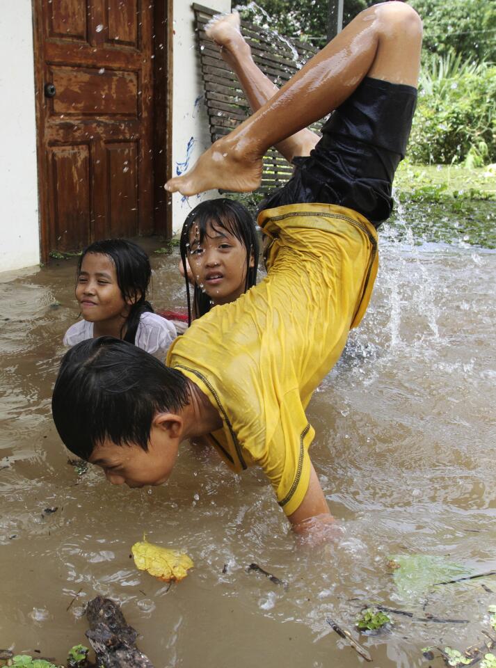 Children play in flood waters in front of their house in Phnom Penh. The death toll from flooding in Thailand since mid-July has risen to 158, while 61 people have died in neighbouring Cambodia in the past two weeks, authorities in the two countries said.
