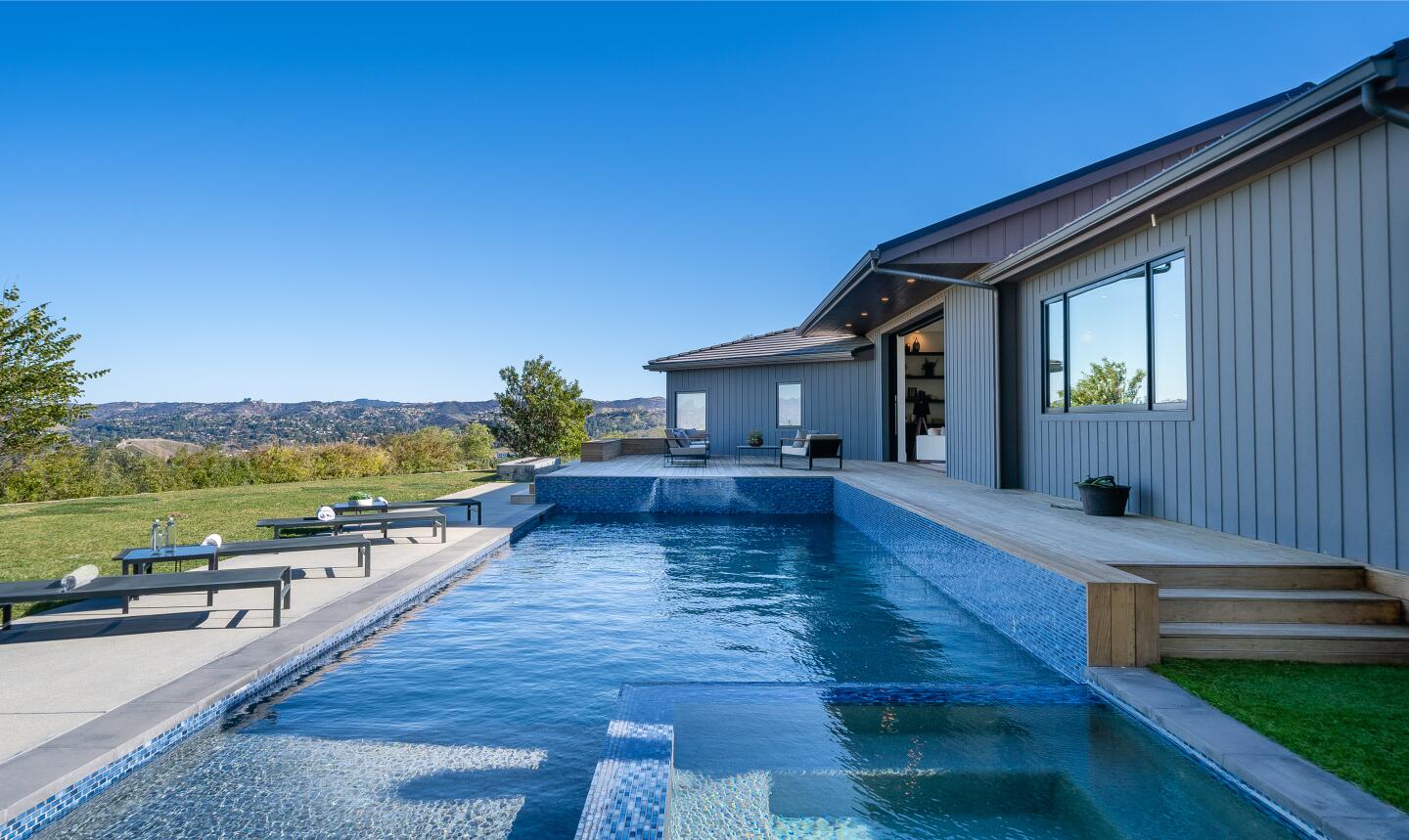 The single-story home sits on 2.3 acres with sweeping city and mountain views.
