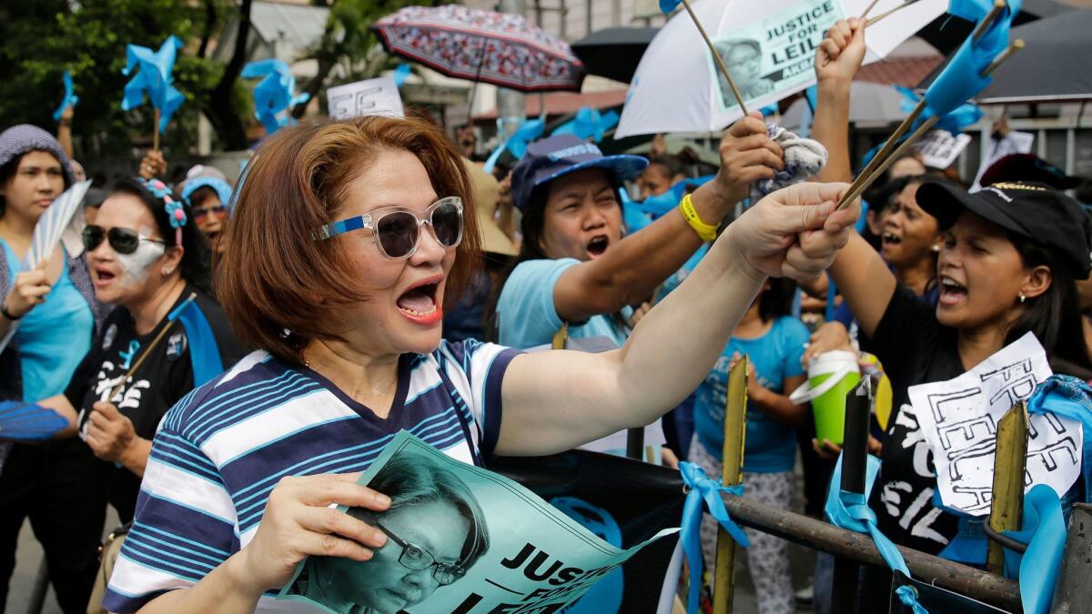 Supporters of detained Philippine Sen. Leila De Lima shout slogans during a rally March 14 outside the Supreme Court in Manila.