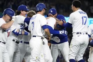 Los Angeles Dodgers' Freddie Freeman, second from right, is mobbed by teammates after hitting a walk-off single during the 11th inning of a baseball game against the Chicago White Sox Thursday, June 15, 2023, in Los Angeles. The Dodgers won 5-4. (AP Photo/Mark J. Terrill)