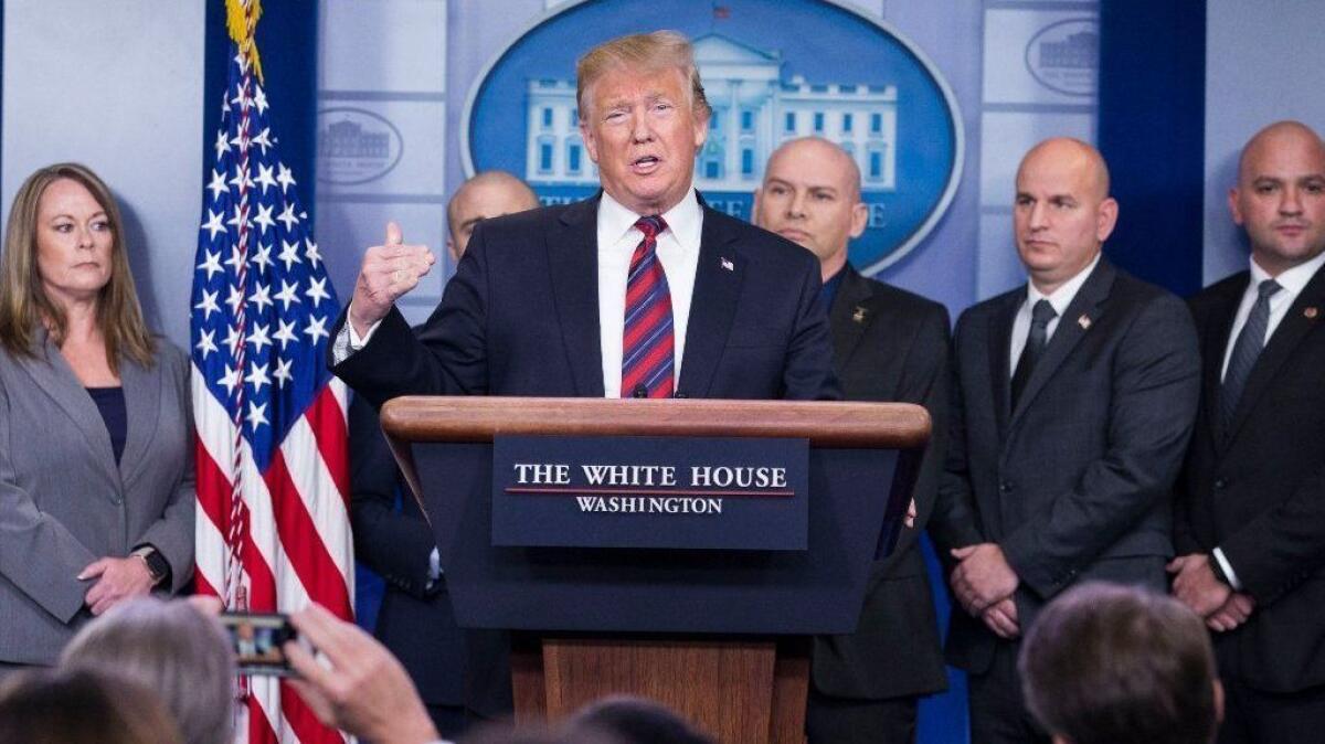 President Trump delivers a statement on border security and the ongoing partial shutdown of the federal government, with members of the National Border Patrol Council, in the White House briefing room.