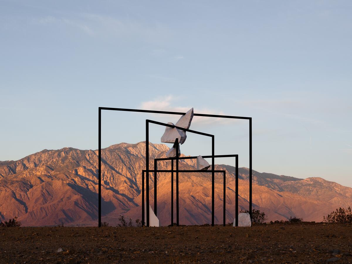 An art installation against a desert mountain.
