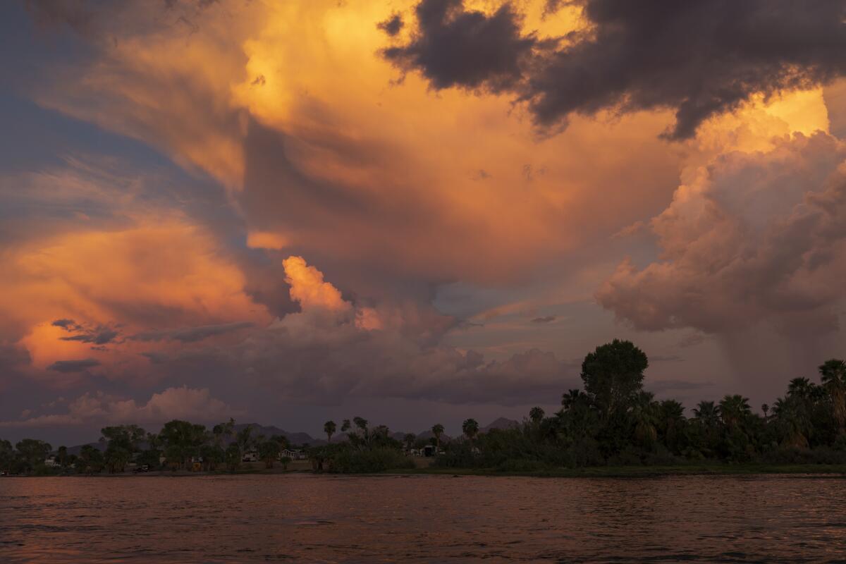 Storm clouds form over a river