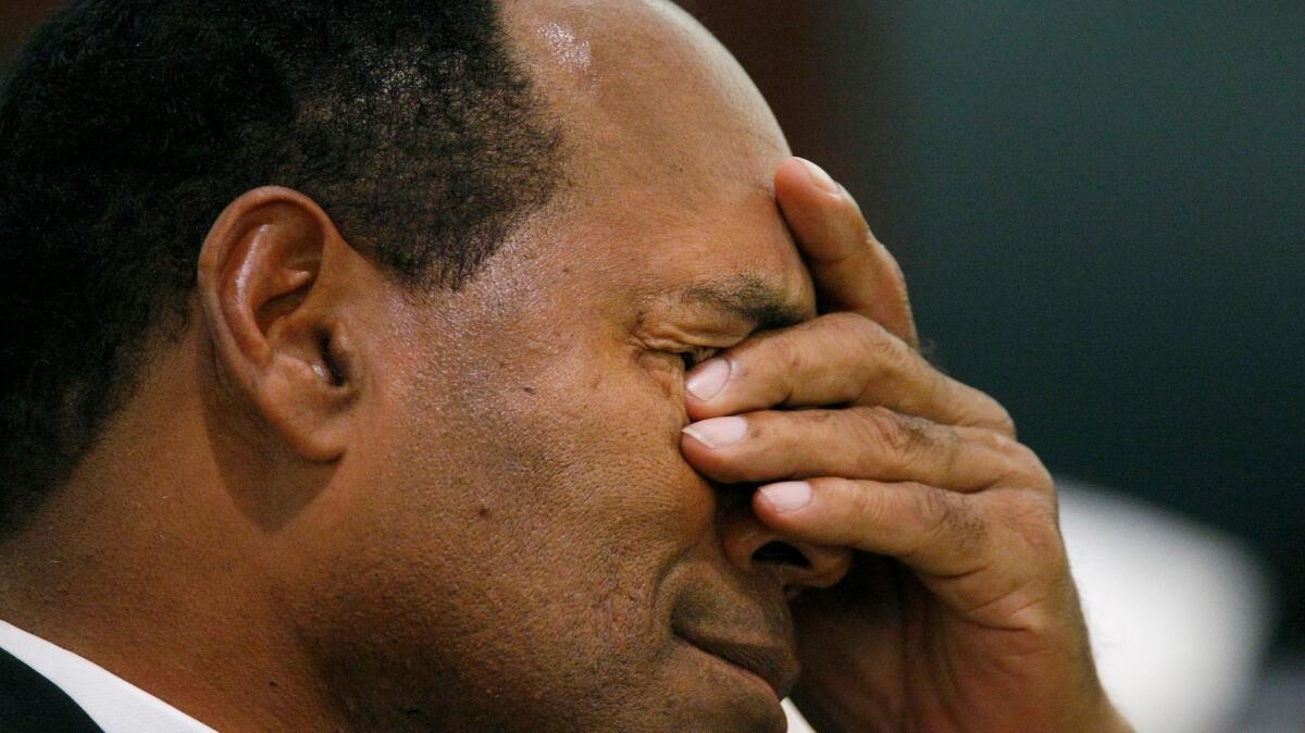 O.J. Simpson rubs his eyes in court during his robbery trial in Las Vegas. (Ethan Miller / Associated Press )