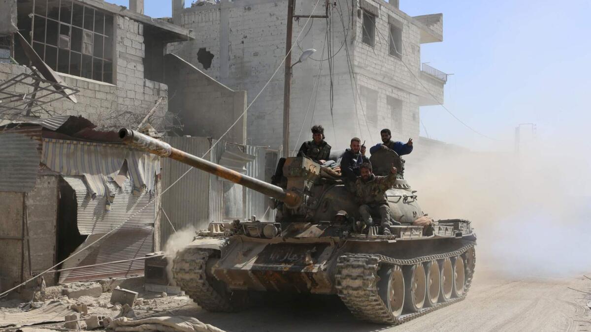 Syrian government forces deploy in the captured town of Beit Sawa in the east Ghouta region.