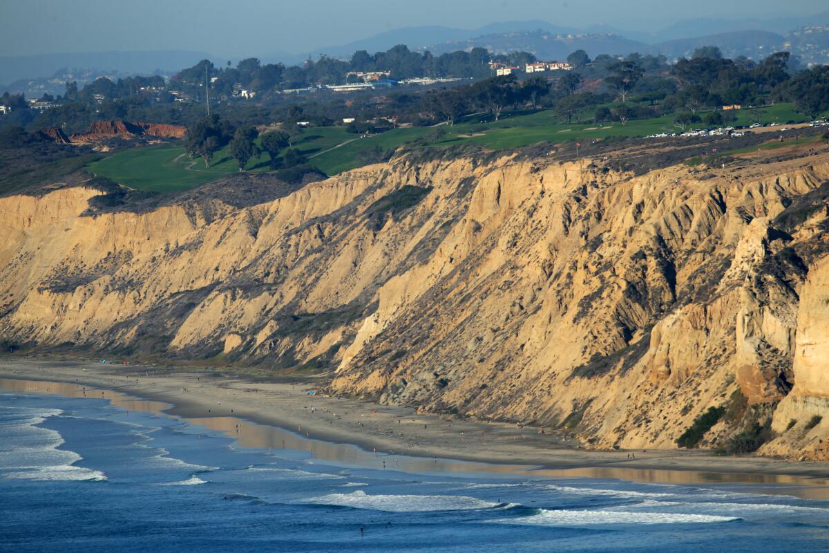 Waves break at below the bluffs of the Torrey Pines Golf Course. Much of San Diego's coastline provides a buffer against flooding.