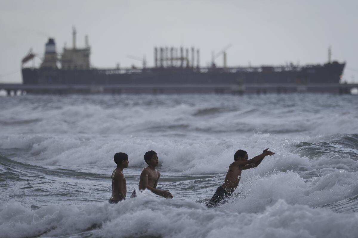 Children play in the waves
