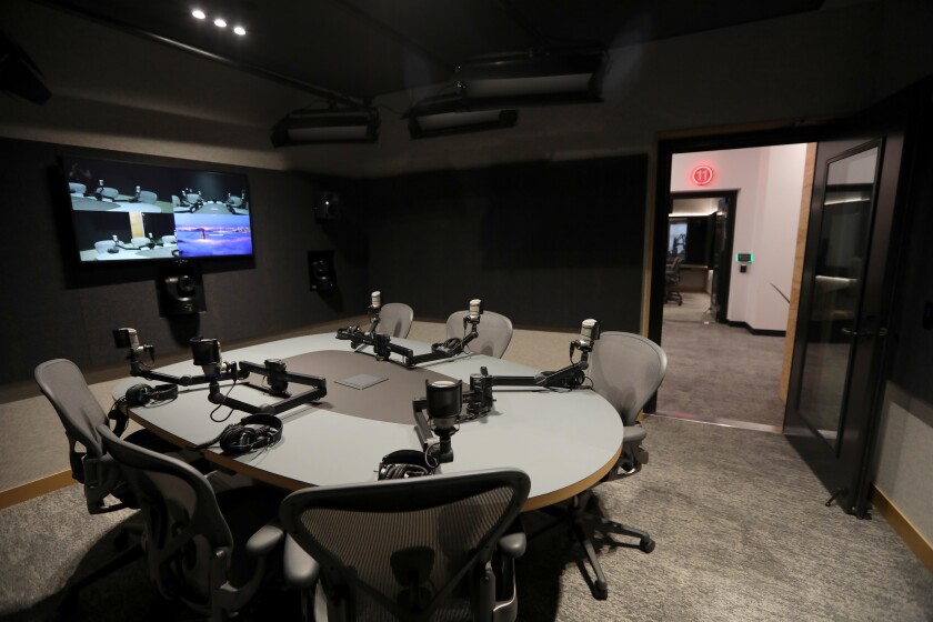 A studio bristling with microphones, remote-control cameras and screens. 