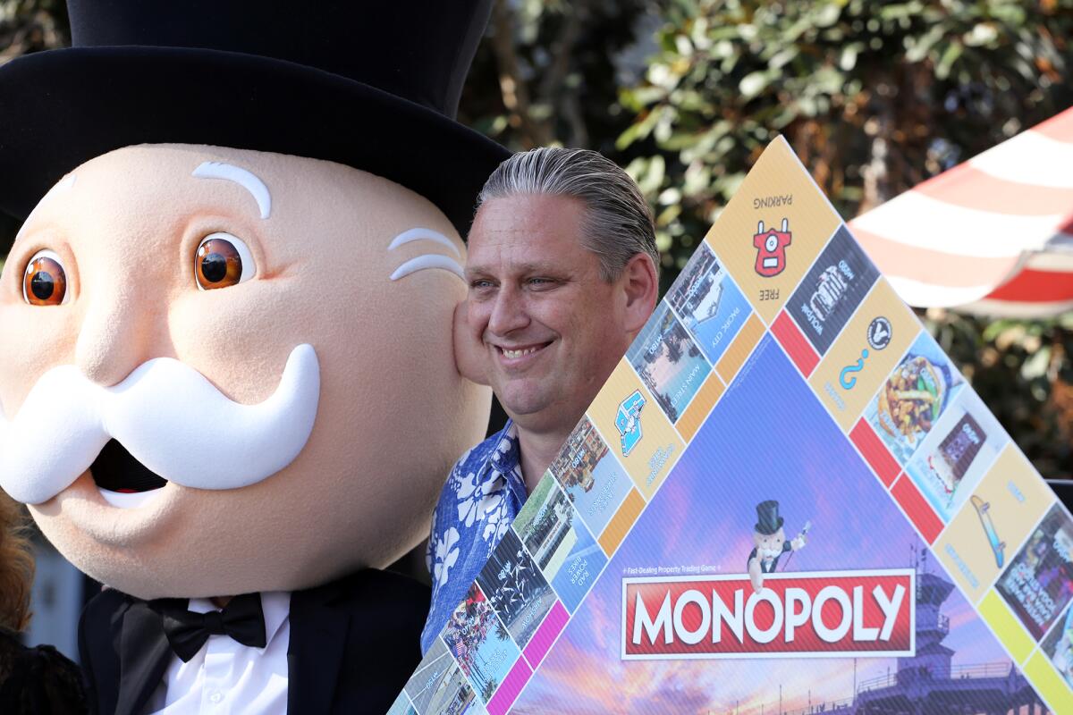 Mr. Monopoly and Huntington Beach Mayor Tony Strickland during Wednesday's event at Pacific City.