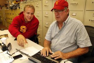 USC quarterback Matt Barkley teaches then-Times sports columnist T. J. Simers how to set up a Twitter account in 2012.