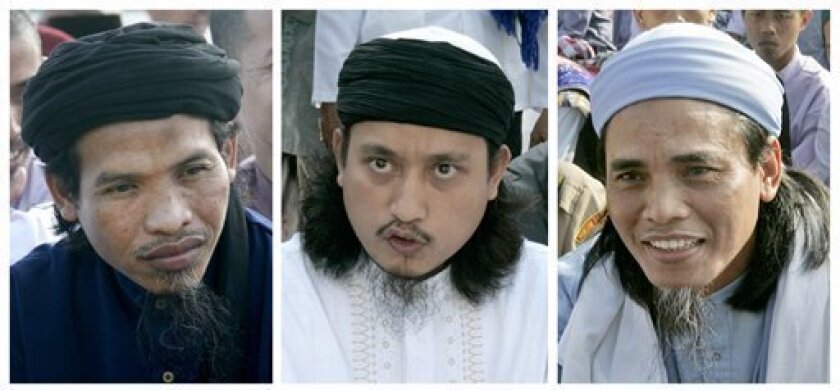 This is a combination of Oct. 1, 2008 file photos of from left to right, Ali Ghufron, Imam Samudra, and Amrozi Nurhasyim. Ali Ghufron, Amrozi Nurhasyim, and Imam Samudra were executed early Sunday Nov. 9, 2008 on the Nusakambangen prison Island for planning and carrying out the 2002 Bali bombings which killed more than 200 people, mostly foreign tourists including 88 Australians, as well as 38 Indonesians.(AP Photo/Dita Alangkara, File)