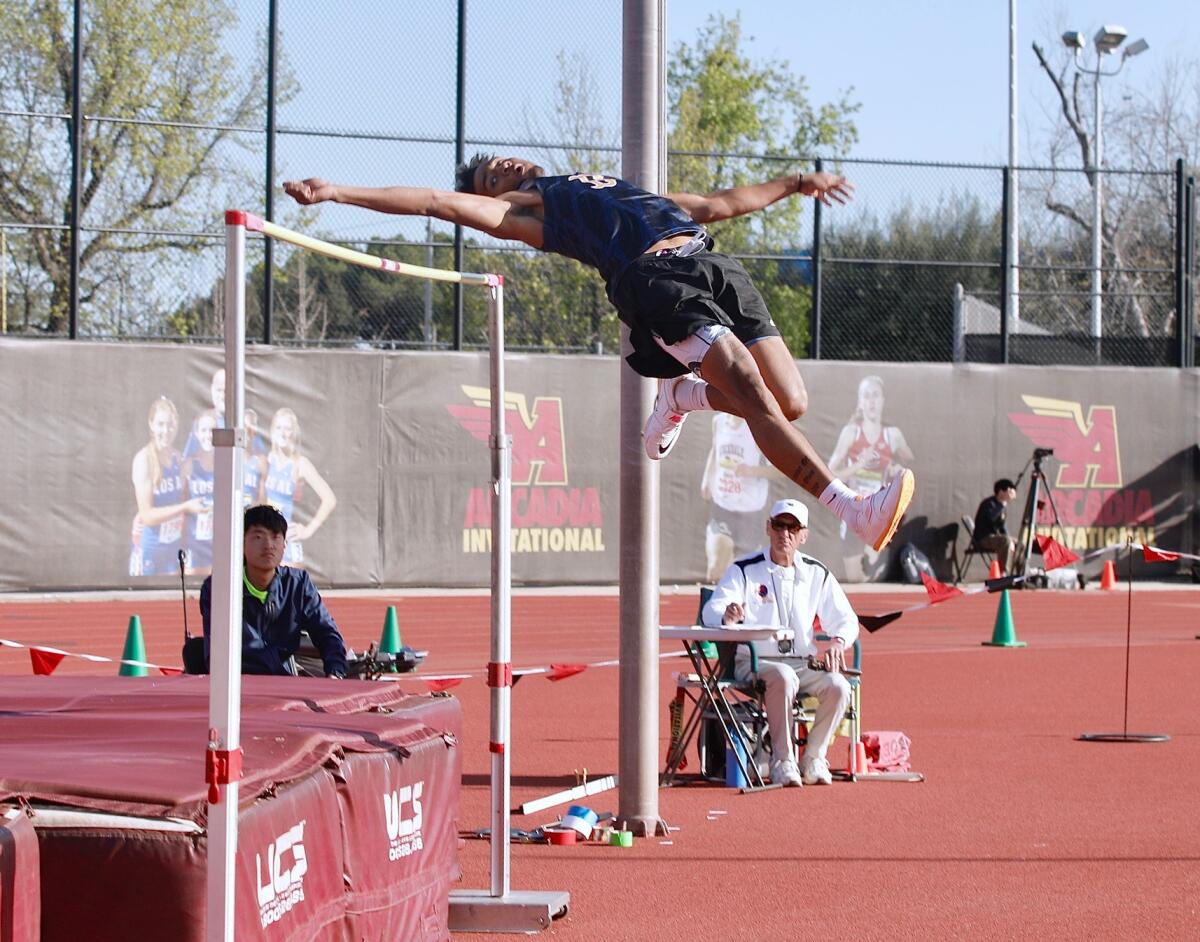 Birmingham senior Deshawn Banks clears the bar at 6 feet 9 inches to win the boys' high jump at the Arcadia Invitational.