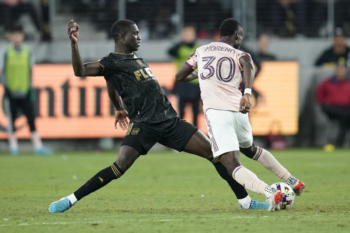 LAFC defender Mamadou Fall vies with Portland midfielder Santiago Moreno for the ball Sunday in Los Angeles. 