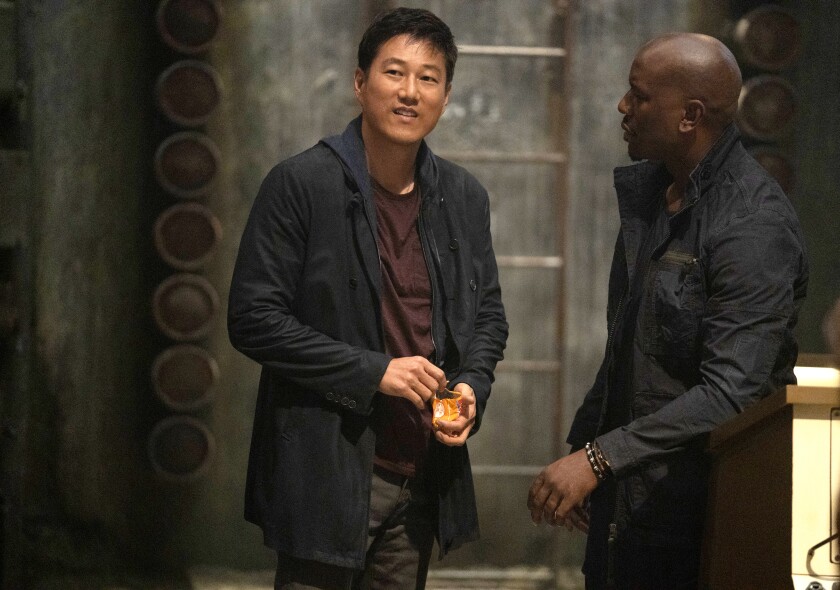 Han (Sung Kang, left) and Roman (Tyrese Gibson) in "F9"