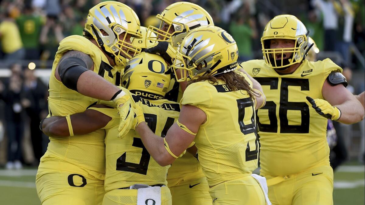 Oregon running back CJ Verdell (34) celebrates with teammates after scoring the winning touchdown in the overtime win against Washington at Autzen Stadium on Oct. 13 in Eugene, Ore.