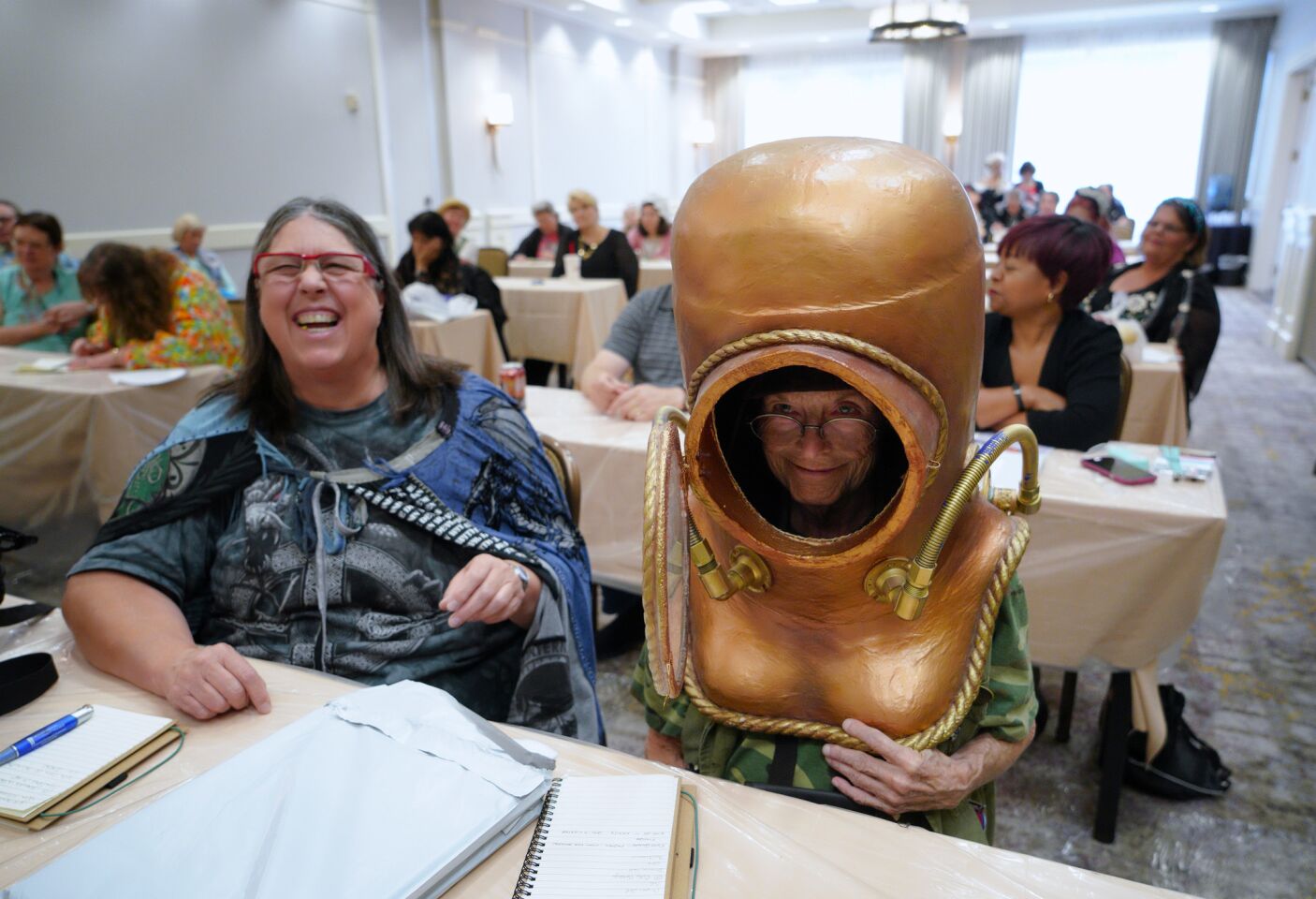 Debbie Bayliss (left) gets big laugh out of Penny Buchanan trying out one of the costume samples during a costume creation workshop held at Costume-Con 2018 in Mission Valley.