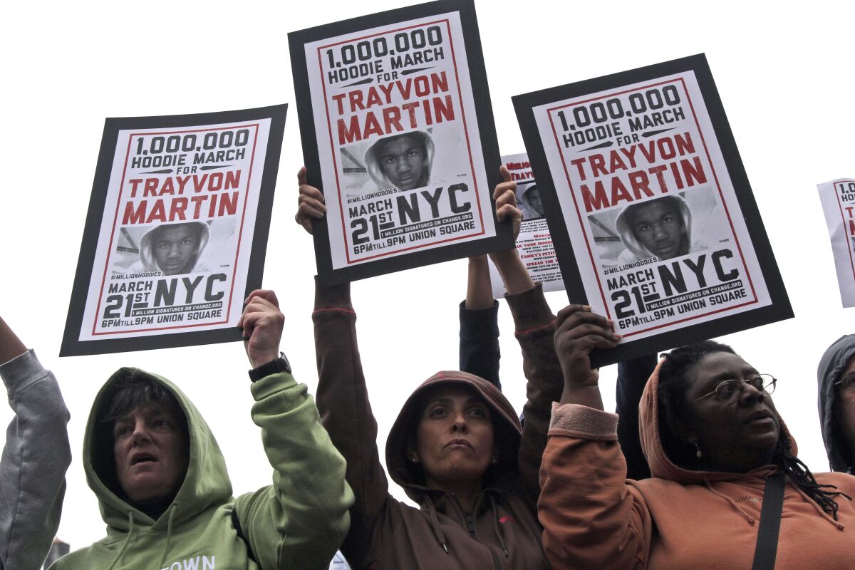 Demonstrators hold signs in support of Trayvon Martin in 2012.
