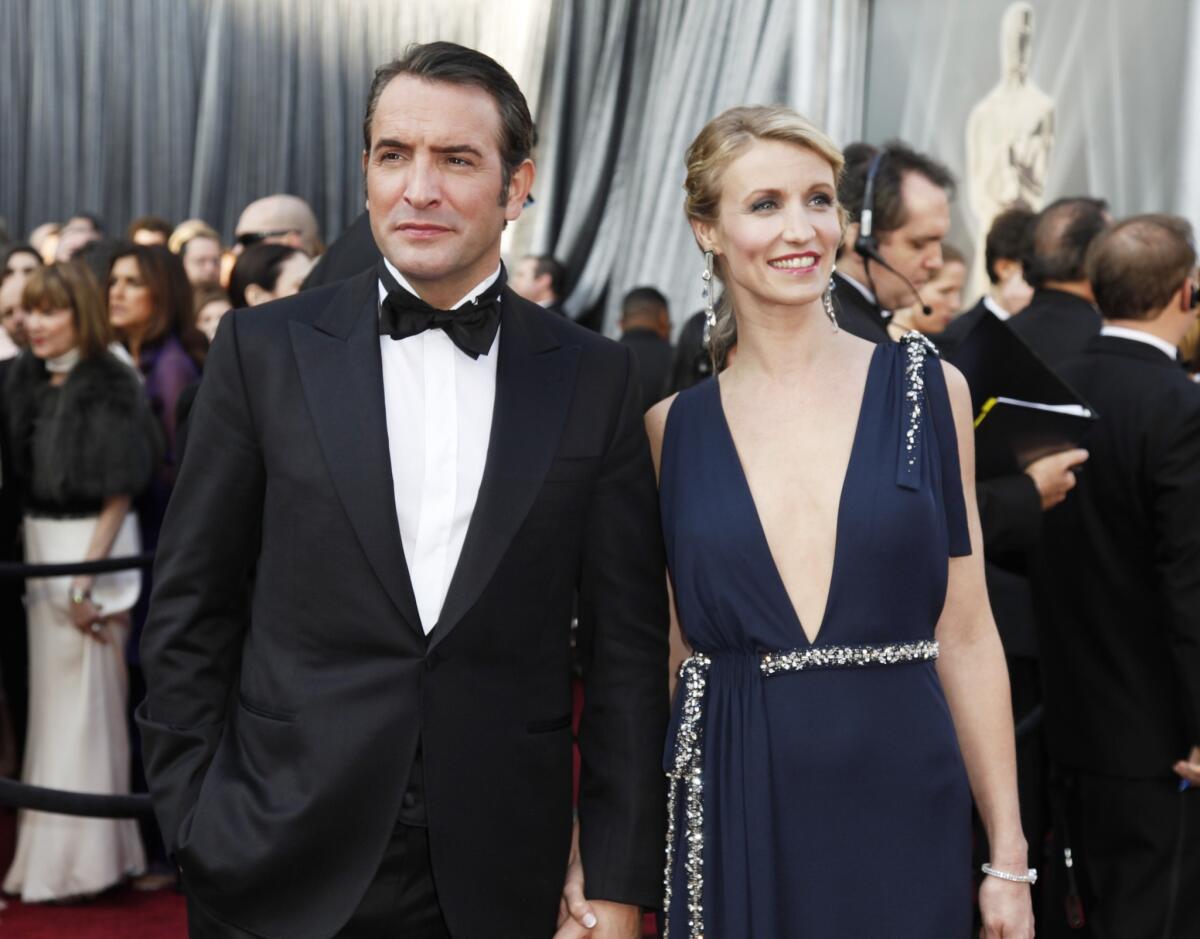 Jean Dujardin of "The Artist" and wife Alexandra Lamy have split. Here the couple appear at the 84th Academy Awards show in Los Angeles in 2012.
