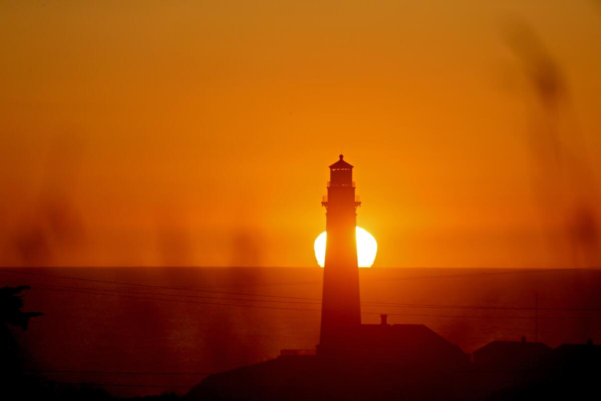 Sunset behind a lighthouse. 
