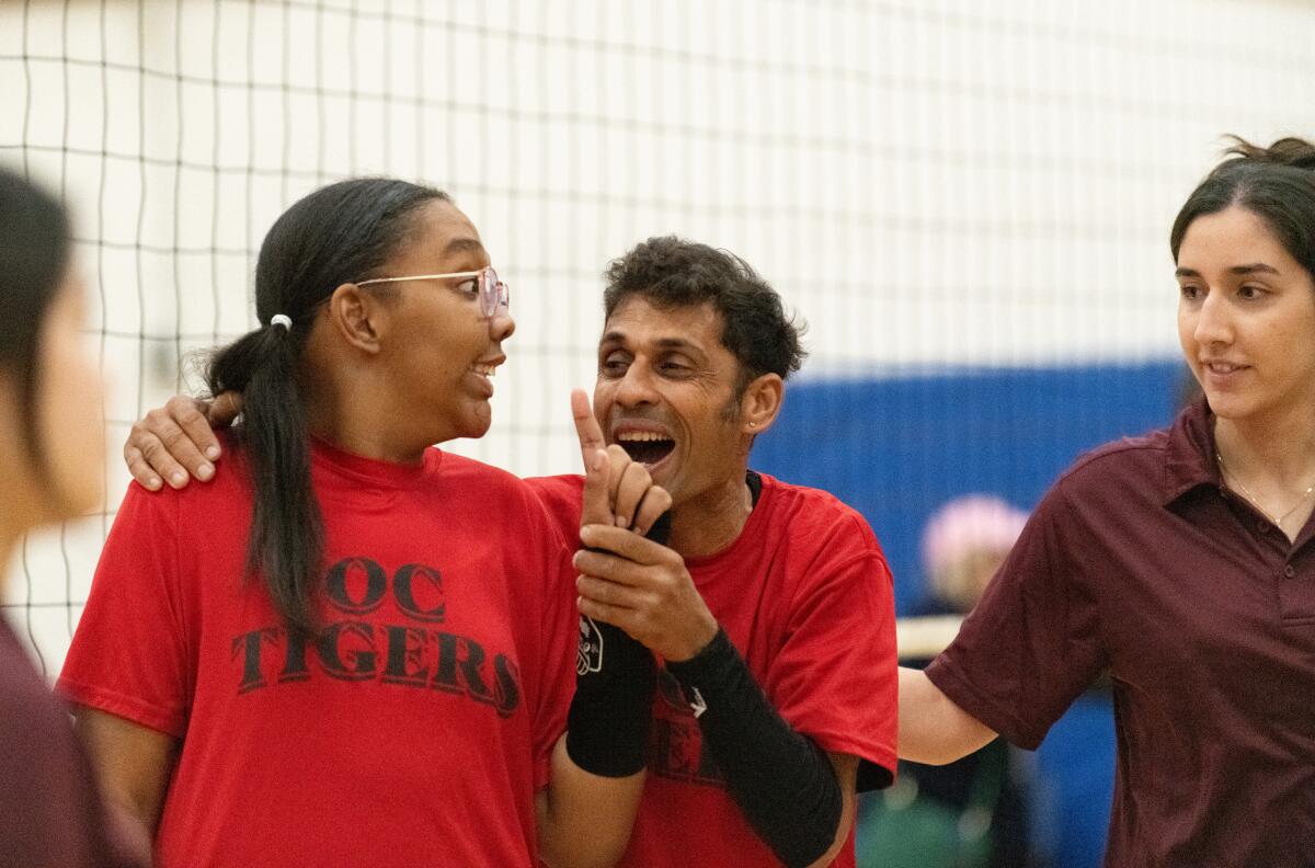 Tiffany Brown and Rajan Randhi of the OC Tigers volleyball team cheer after winning a match.