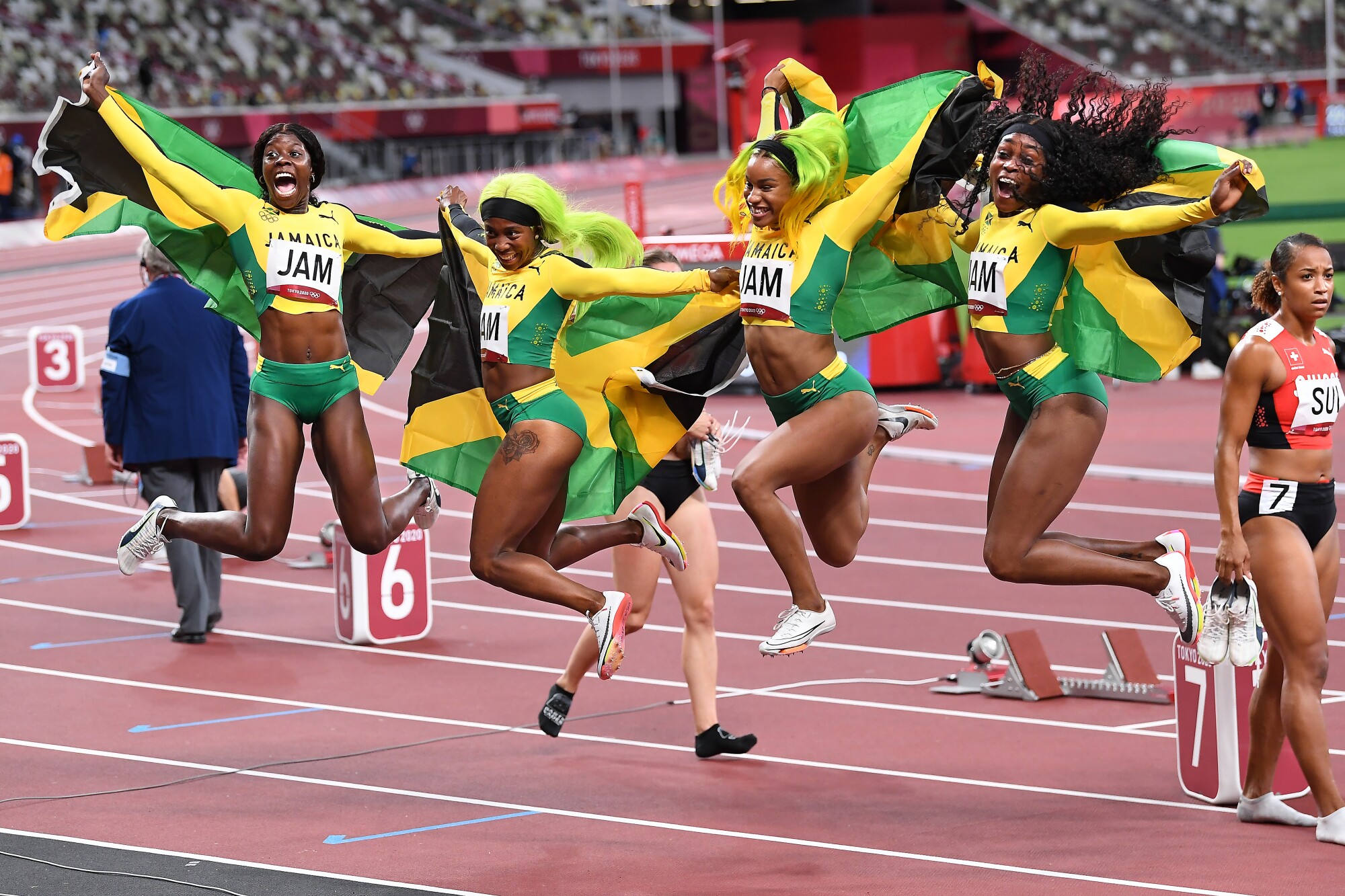 The Jamaica women's 4 X100 team leaps into the air in celebration