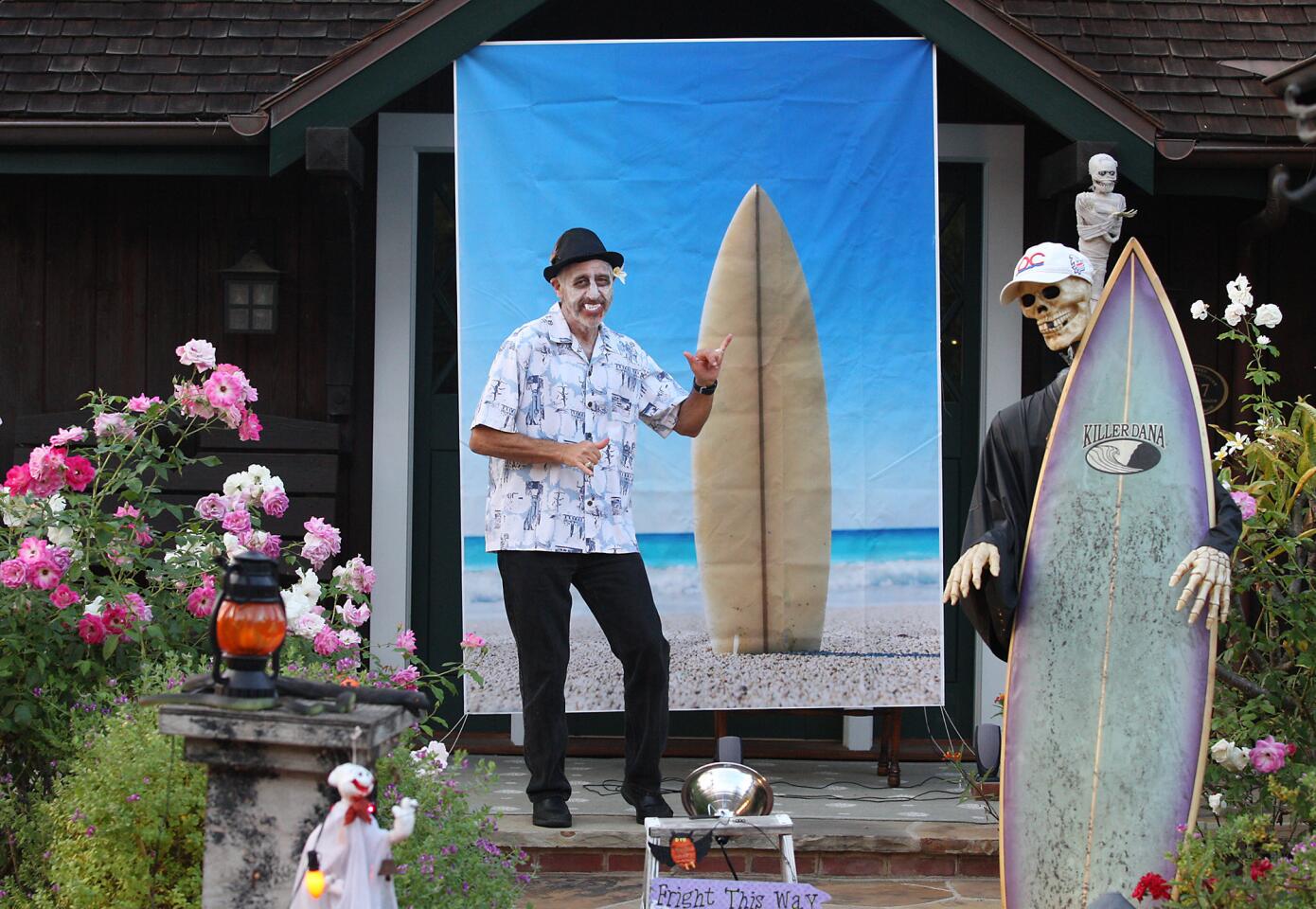 A homeowner dressed as a ghastly surfer dude dances to surf music in front of his home during the Oak Street Halloween Block Party in Laguna Beach on Tuesday evening.
