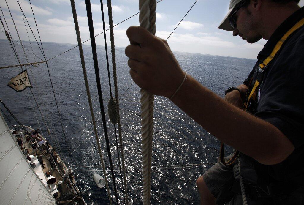 Max McClorey, a crew member aboard the Sea Education Assn.'s brigantine Robert C. Seamans, watches as a net is deployed to collect marine specimens that will be studied in labs at the University of San Diego.