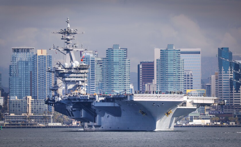 The aircraft carrier USS Theodore Roosevelt, flagship of Carrier Strike Group 9, travels through San Diego Bay before its scheduled deployment to the U.S. Indo-Pacific Command region in January.