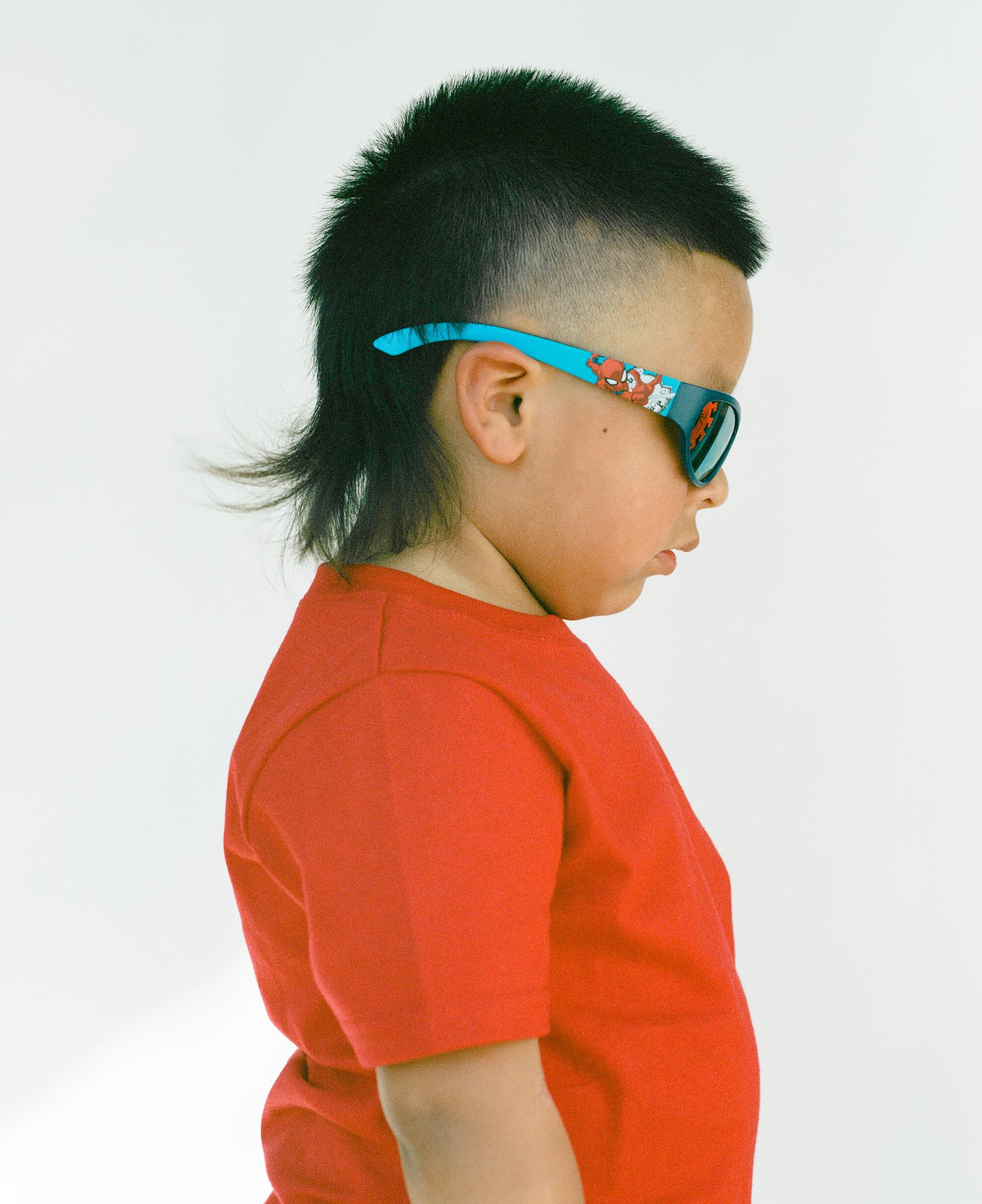 Photo of a child with a mullet.
