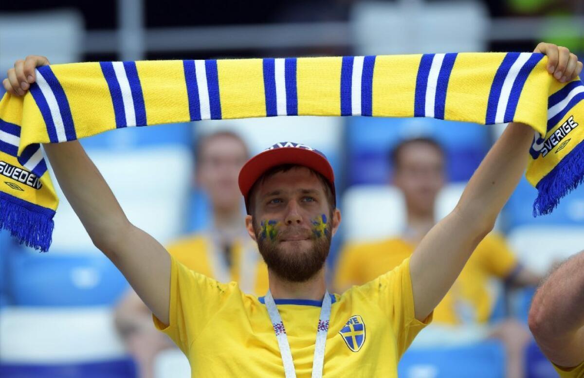A Sweden supporter holds up a scarf ahead of a World Cup Group F match between Sweden and South Korea on June 18, 2018.