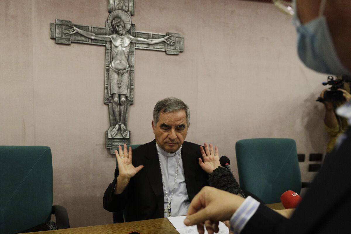FILE - In this Sept. 25, 2020 Cardinal Angelo Becciu talks to journalists during a press conference in Rome. Italy’s financial police said Wednesday, Oct. 14, 2020 that a Sardinian woman, Cecilia Marogna, said to be close to one of the Holy See’s most powerful cardinals, Becciu, before his downfall, was arrested in Milan, northern Italy, late Tuesday on an international warrant issued by the Vatican City State. (AP Photo/Gregorio Borgia, file)