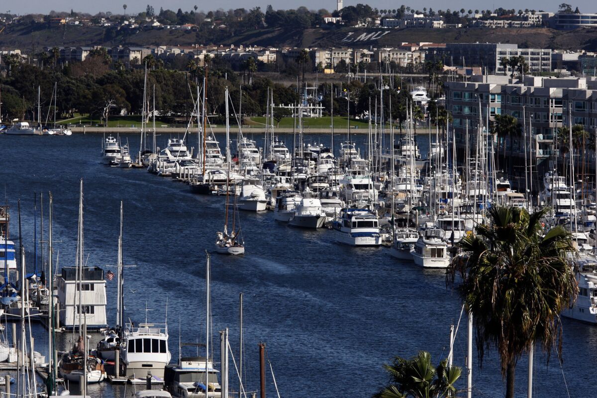 A sailboat motors through Marina del Rey Harbor, which is home to more than 4,500 boats where the Los Angeles Regional Water Quality Board's is considering a plan that would force boat owners to strip the copper paint off the bottom of their boats at their personal expense.